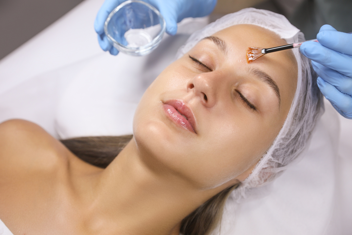 Cosmetologist Applying Chemical Peel Product on Client's Face in